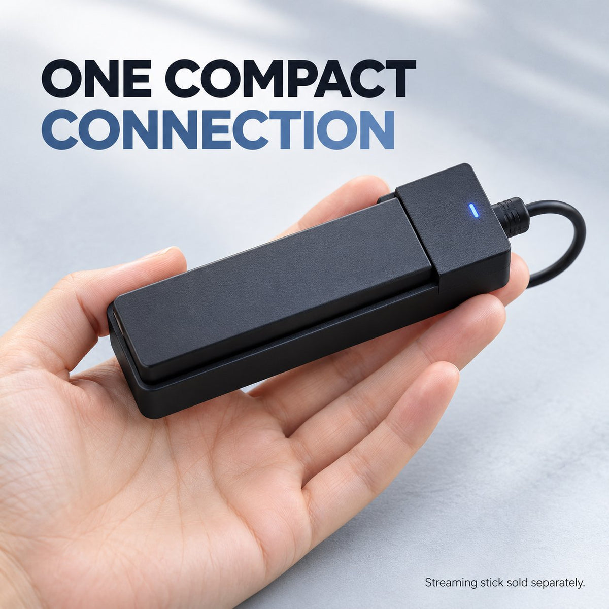 Compact black car adapter with short cable and blue status indicator shown in hand