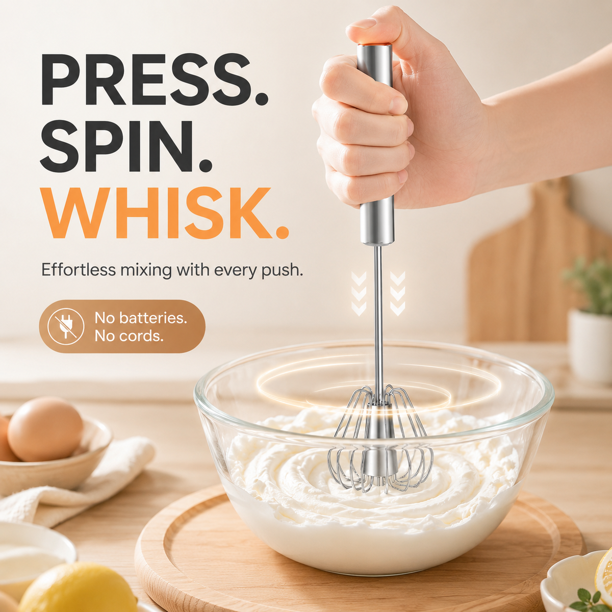 Hand push rotary whisk spinning in a bowl of cream