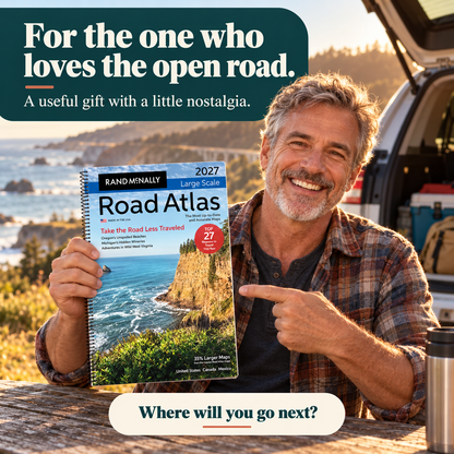 Road trip enthusiast holding the 2027 atlas as a useful travel gift