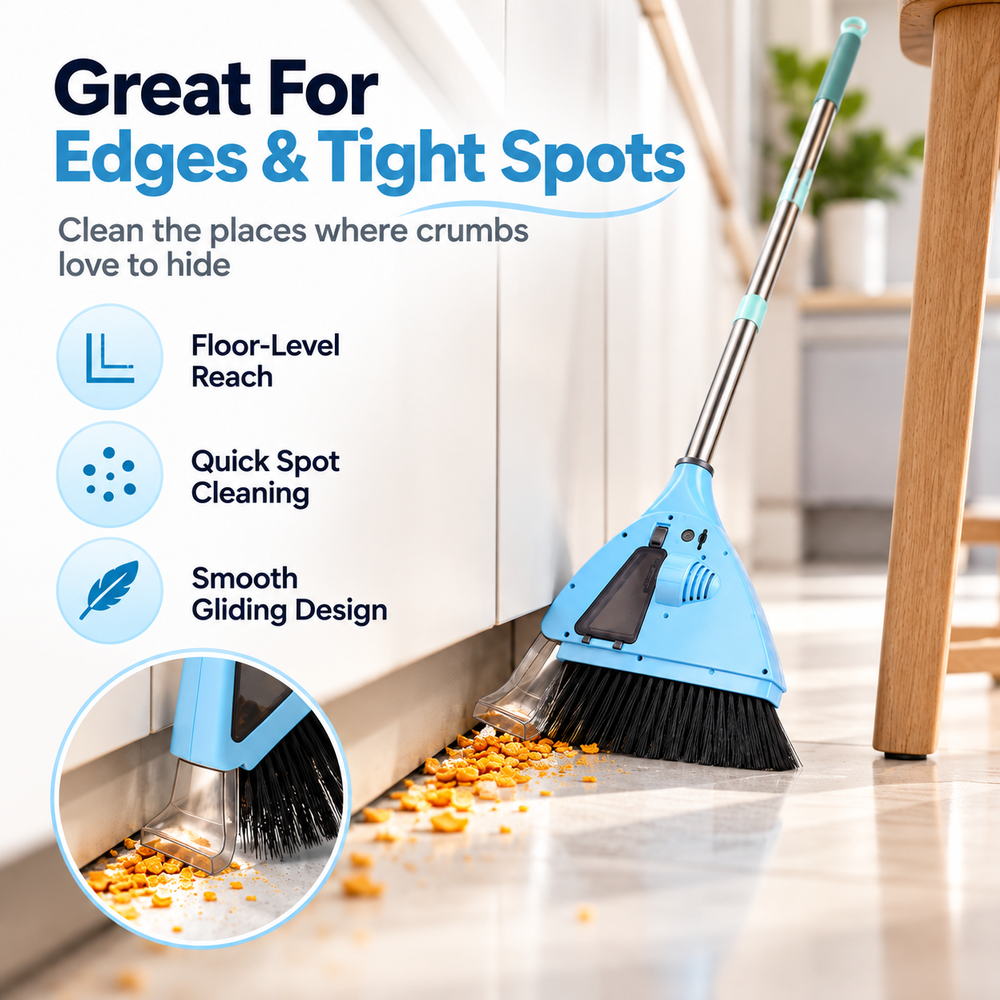 Angled light blue electric floor sweeper brushing dry cereal crumbs along the base of a kitchen cabinet