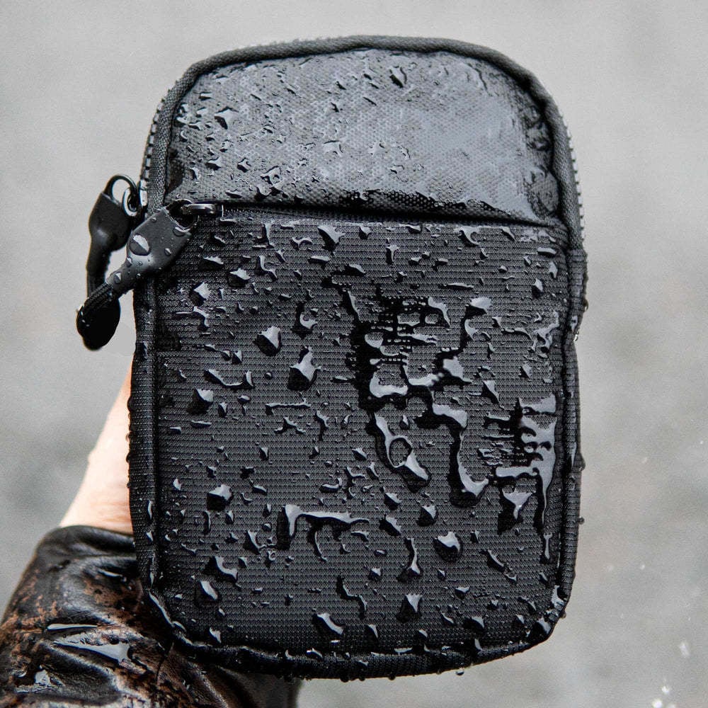 Water-resistant nylon sling bag covered with water droplets