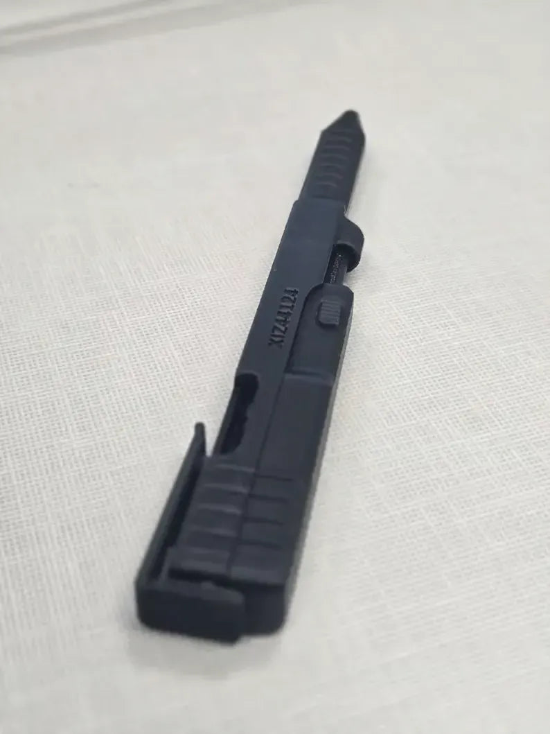 Close side view of slide-action mechanism on black novelty pen
