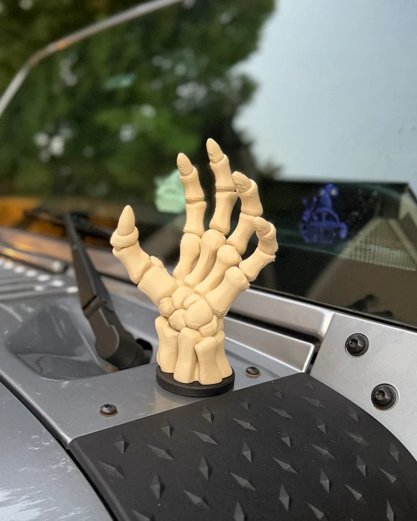 Open skeletal hand magnetic vehicle accessory outdoors