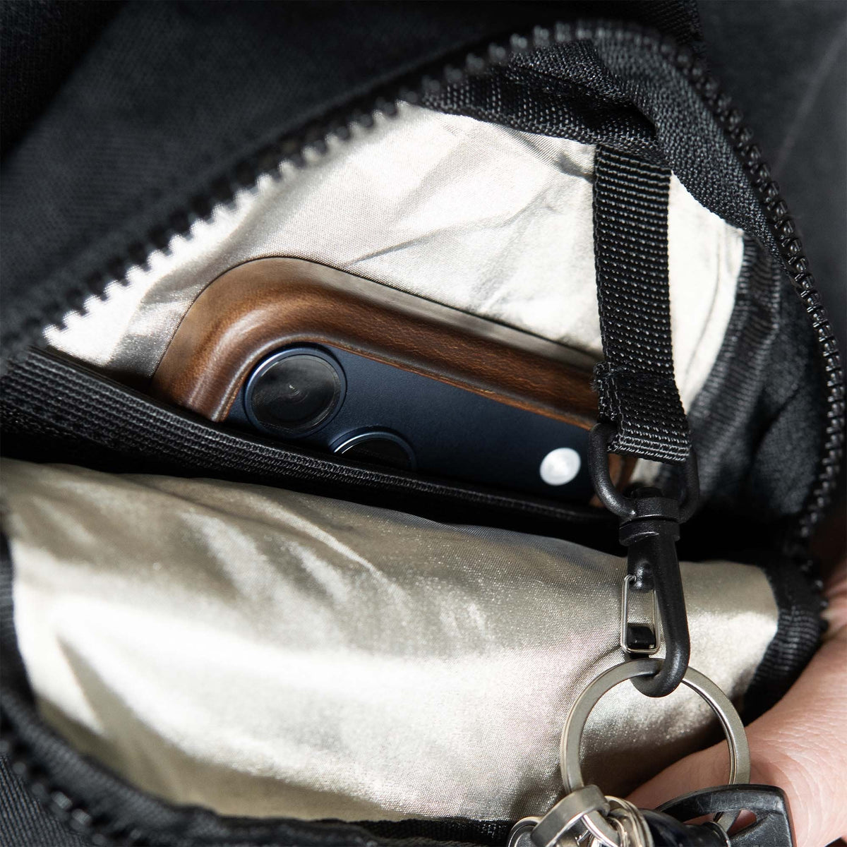 Interior key clip and organized pocket inside sling bag