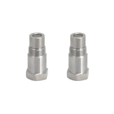 Two stainless steel oxygen sensor spacer adapters displayed upright, showing the machined metal finish and threaded construction