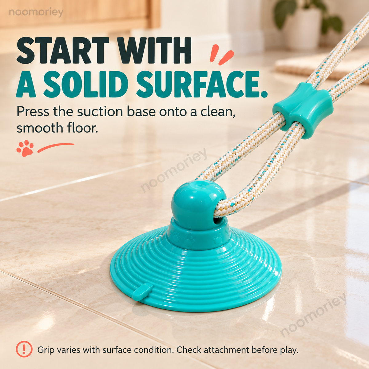 Teal suction cup tug toy attached to a smooth tile surface