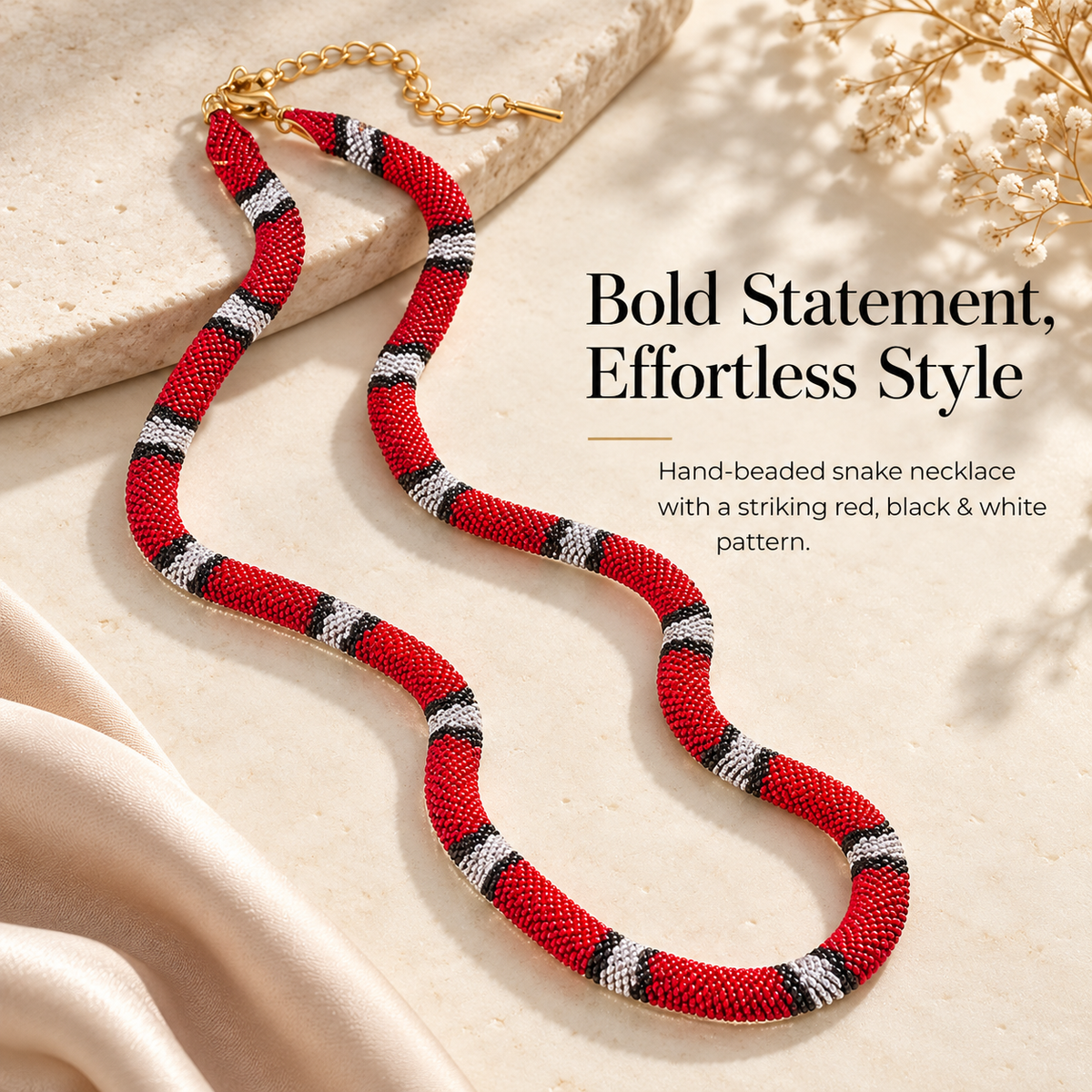 Close presentation of the red black and white woven snake necklace showing its textured surface and serpentine shape