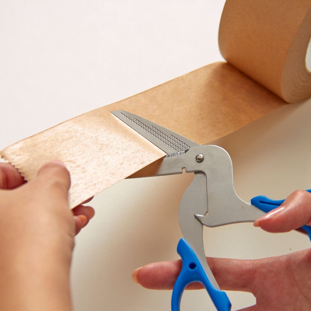 Multi-purpose scissors cutting sticky packaging tape