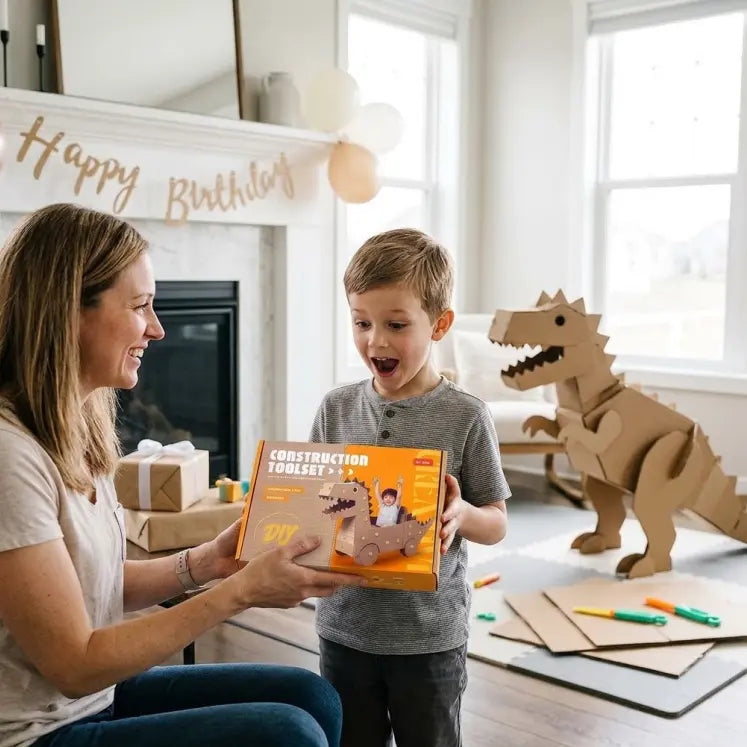 Child excitedly receiving cardboard construction tool set as birthday gift while handmade cardboard dinosaur stands nearby