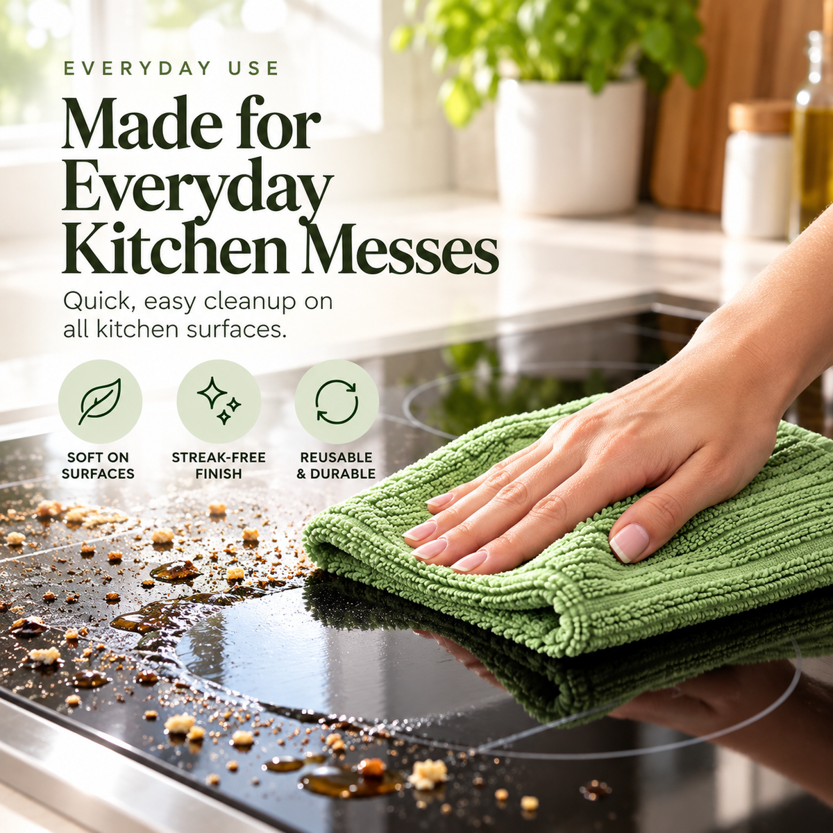Reusable green kitchen towel wiping crumbs and residue from smooth cooktop