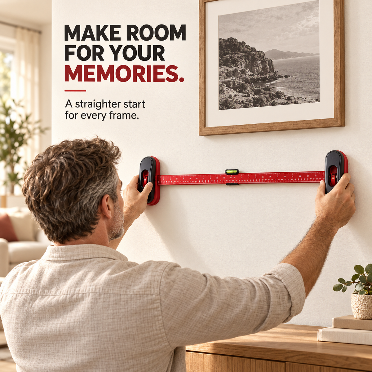 Homeowner positioning a picture hanging guide against a wall